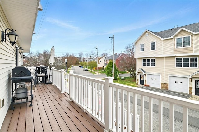 deck with an attached garage and a residential view
