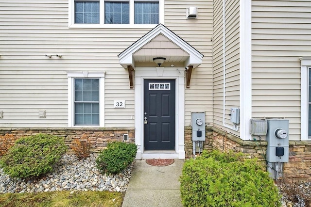 view of exterior entry featuring stone siding