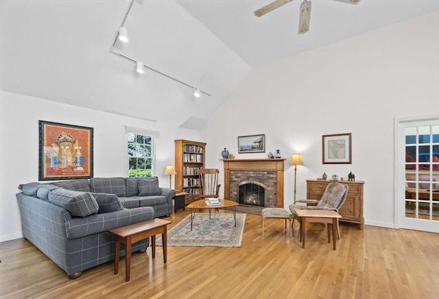 21 Gramps Way, Chatham, MA 02659 - living area with rail lighting, light wood-style floors, a ceiling fan, a fireplace, and high vaulted ceiling