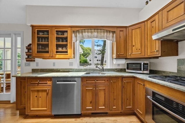 21 Gramps Way, Chatham, MA 02659 - kitchen with appliances with stainless steel finishes, light wood-type flooring, and brown cabinets