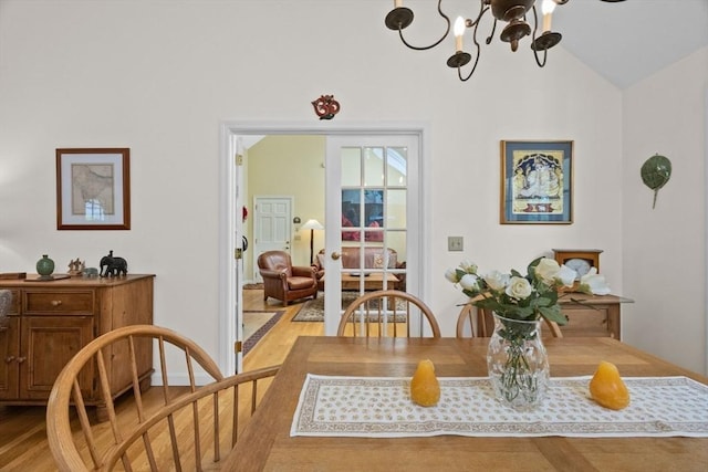 21 Gramps Way, Chatham, MA 02659 - dining space with light wood-style flooring, vaulted ceiling, and a chandelier