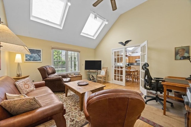 21 Gramps Way, Chatham, MA 02659 - living room featuring wood finished floors, a skylight, high vaulted ceiling, a desk, and a ceiling fan