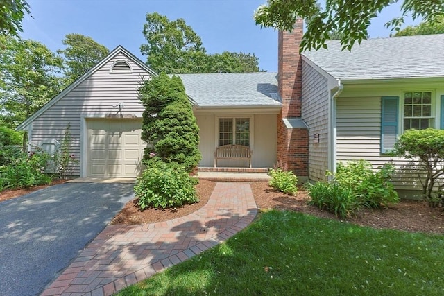 21 Gramps Way, Chatham, MA 02659 - view of front of property with a chimney, driveway, a garage, and roof with shingles