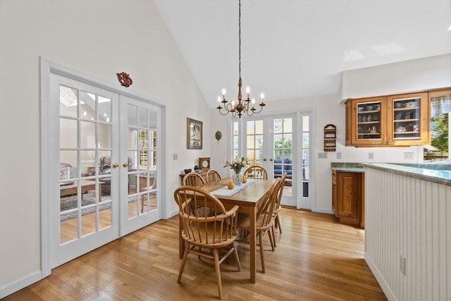 21 Gramps Way, Chatham, MA 02659 - dining area featuring french doors, light wood-style flooring, a chandelier, healthy amount of natural light, and high vaulted ceiling