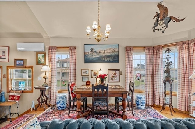 1 Carter Ave, Salisbury, MA 01952 - dining space with a wall mounted AC, wood finished floors, and a chandelier