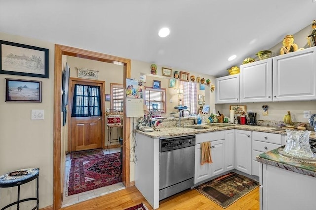 1 Carter Ave, Salisbury, MA 01952 - kitchen with dishwasher, white cabinets, light wood-style flooring, light stone countertops, and vaulted ceiling