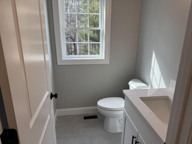 bathroom with tile patterned flooring, toilet, visible vents, vanity, and baseboards