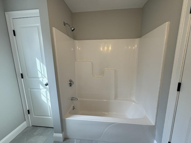 full bathroom with shower / tub combination and baseboards