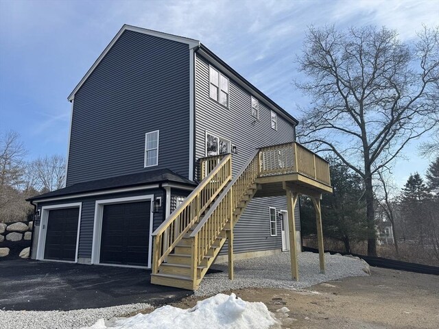 exterior space with driveway, stairway, and an attached garage