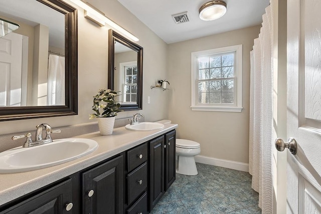 bathroom featuring toilet and vanity