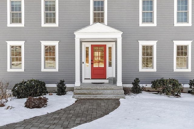 view of snow covered property entrance