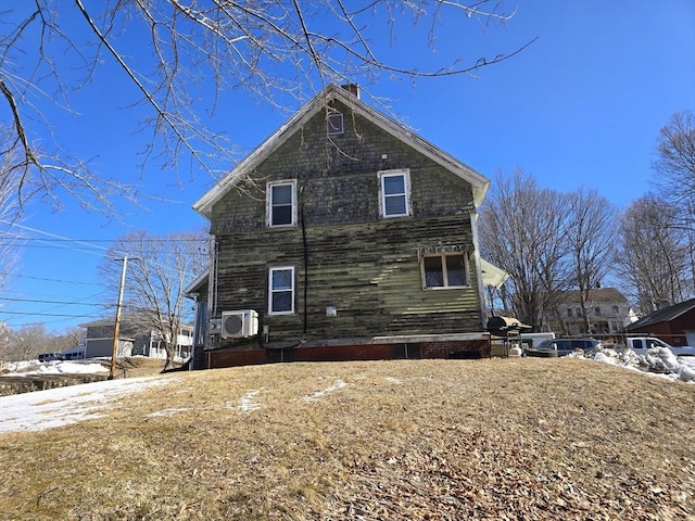 view of property exterior featuring a chimney