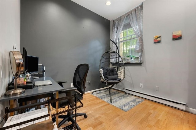 350 W 4th St Unit 103, Boston, MA 02127 - home office with a baseboard radiator, wood finished floors, and baseboards