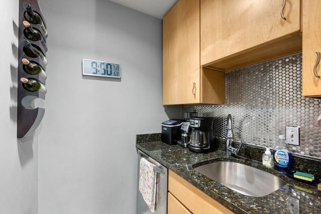 350 W 4th St Unit 103, Boston, MA 02127 - kitchen with a sink, tasteful backsplash, stainless steel dishwasher, dark stone counters, and light brown cabinets