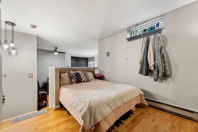 350 W 4th St Unit 103, Boston, MA 02127 - bedroom with wood finished floors, baseboard heating, and ceiling fan