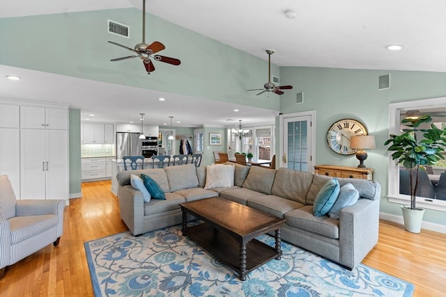 living area featuring visible vents, recessed lighting, light wood finished floors, and ceiling fan with notable chandelier