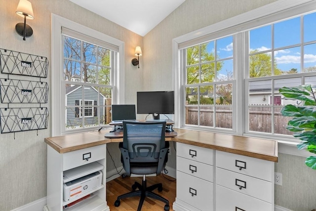 office space with baseboards, wallpapered walls, and wood finished floors