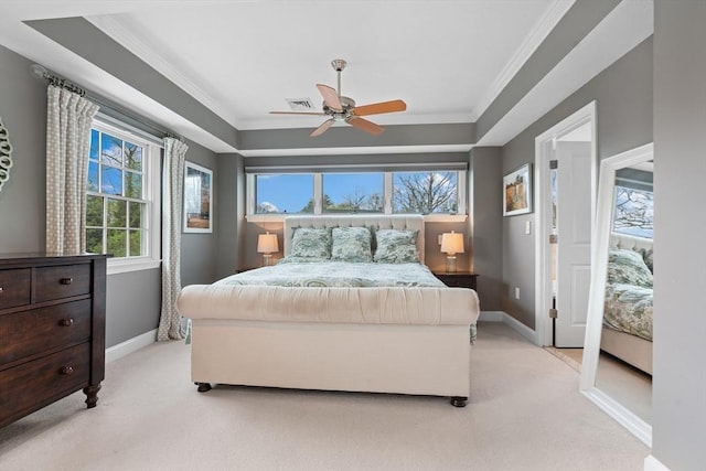 bedroom featuring crown molding, baseboards, and light colored carpet