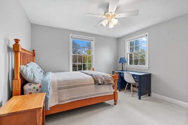 bedroom featuring a ceiling fan, baseboards, and light carpet