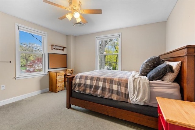 bedroom featuring baseboards, light colored carpet, ceiling fan, and visible vents