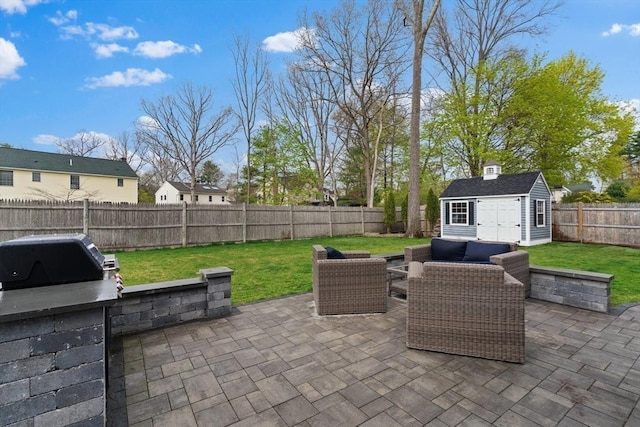 view of patio with an outdoor living space, an outbuilding, a fenced backyard, and a shed