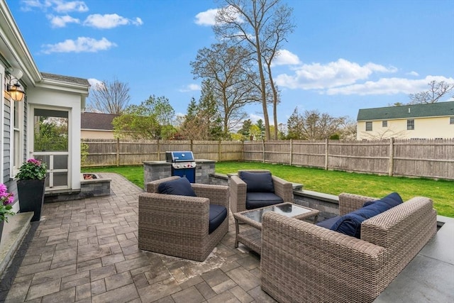 view of patio / terrace featuring a fenced backyard, an outdoor hangout area, and area for grilling