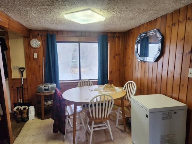 18 Central St, Ashburnham, MA 01430 - dining space with light flooring, wooden walls, and a textured ceiling