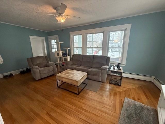 living room featuring crown molding, a wealth of natural light, and ceiling fan