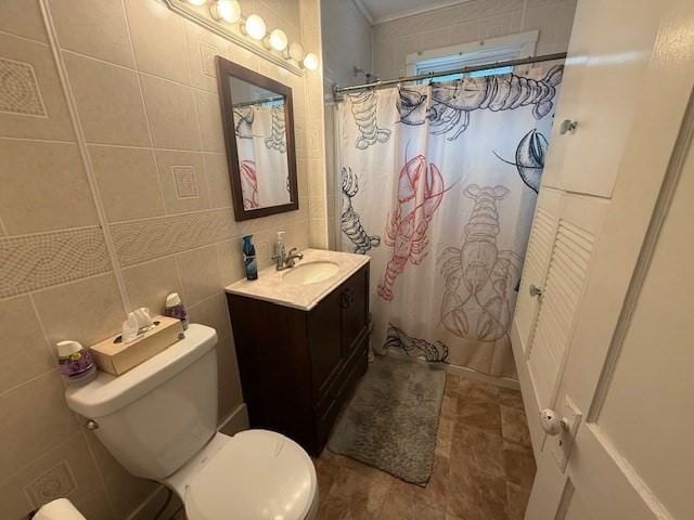 bathroom with walk in shower, vanity, toilet, and tile walls