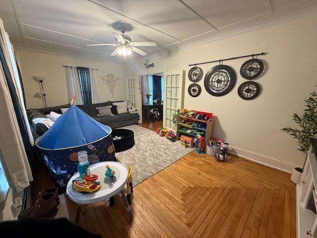 living room with hardwood / wood-style flooring, ornamental molding, french doors, and ceiling fan