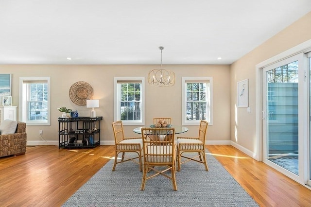 dining room featuring light hardwood / wood-style floors and a notable chandelier