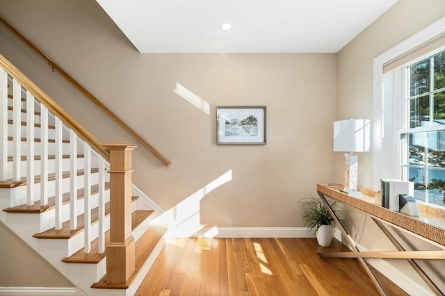 stairway with hardwood / wood-style floors