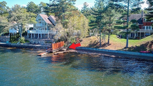 exterior space with a lawn and a water view