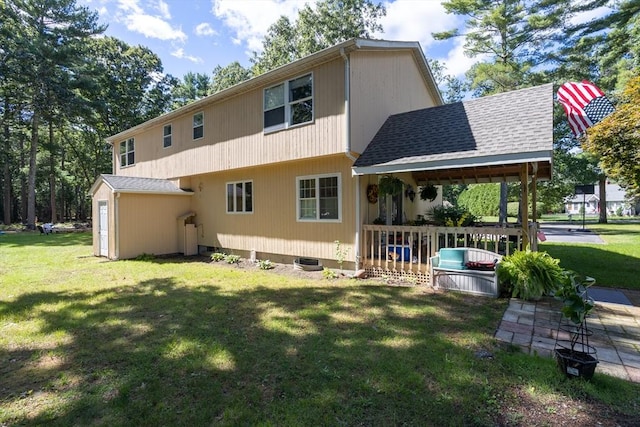 back of house featuring a porch and a lawn