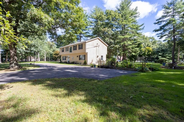 exterior space with a trampoline and a yard