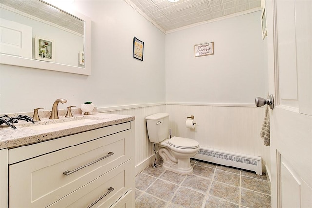 bathroom with toilet, baseboard heating, ornamental molding, and vanity