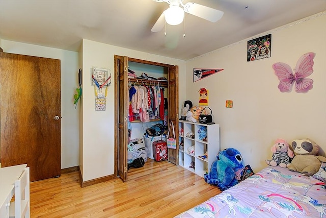 bedroom with ceiling fan, light hardwood / wood-style floors, and a closet