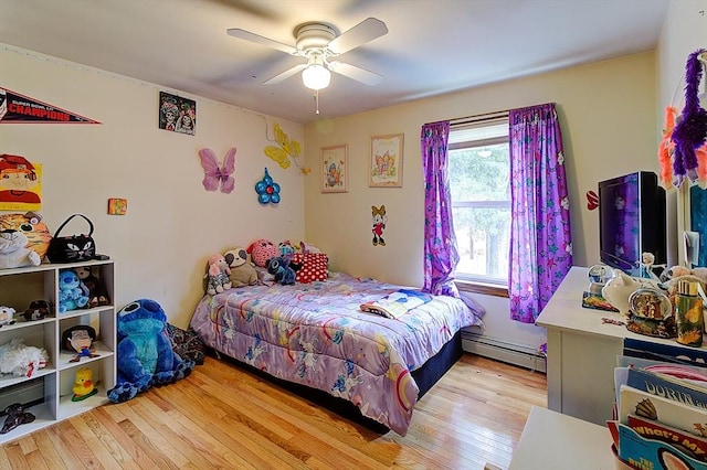 bedroom with light wood-type flooring, ceiling fan, multiple windows, and a baseboard radiator