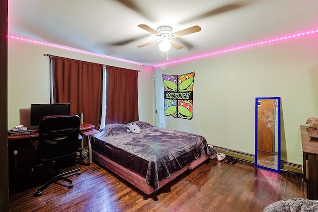 bedroom with ceiling fan, dark wood-type flooring, and a baseboard heating unit