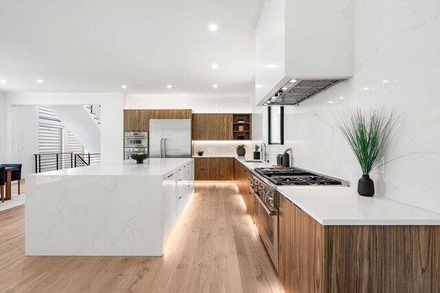 17 Prospect Hill Rd, Lexington, MA 02420 - kitchen with modern cabinets, exhaust hood, brown cabinets, open shelves, and appliances with stainless steel finishes