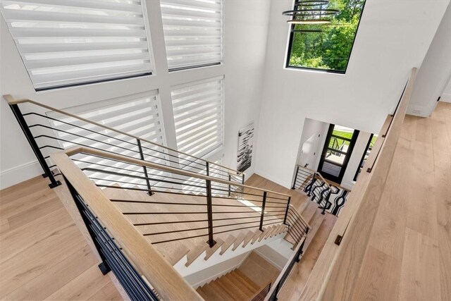 17 Prospect Hill Rd, Lexington, MA 02420 - staircase featuring a towering ceiling, wood finished floors, and baseboards