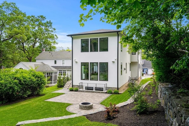 17 Prospect Hill Rd, Lexington, MA 02420 - rear view of property featuring an outdoor fire pit, a patio area, a lawn, and stucco siding