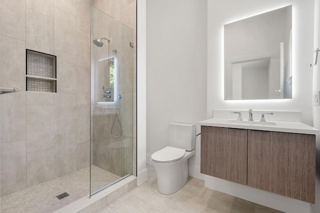 17 Prospect Hill Rd, Lexington, MA 02420 - bathroom featuring a tile shower, toilet, vanity, tile patterned flooring, and baseboards