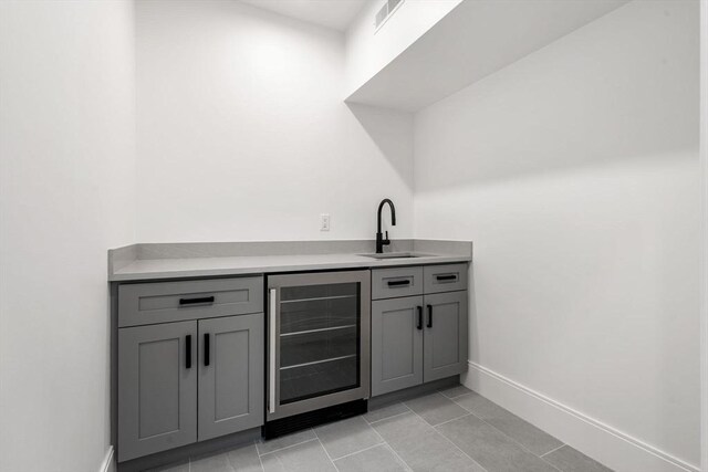 17 Prospect Hill Rd, Lexington, MA 02420 - indoor wet bar featuring wine cooler, baseboards, and light tile patterned flooring