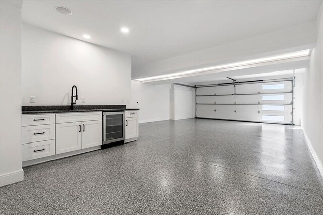 17 Prospect Hill Rd, Lexington, MA 02420 - garage featuring wine cooler, a sink, baseboards, and recessed lighting