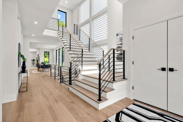 17 Prospect Hill Rd, Lexington, MA 02420 - entryway with light wood-style floors, recessed lighting, a towering ceiling, stairway, and baseboards