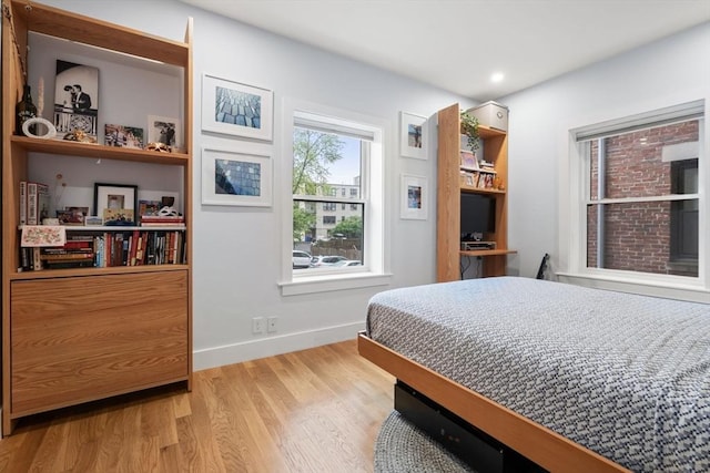 bedroom with wood finished floors and baseboards