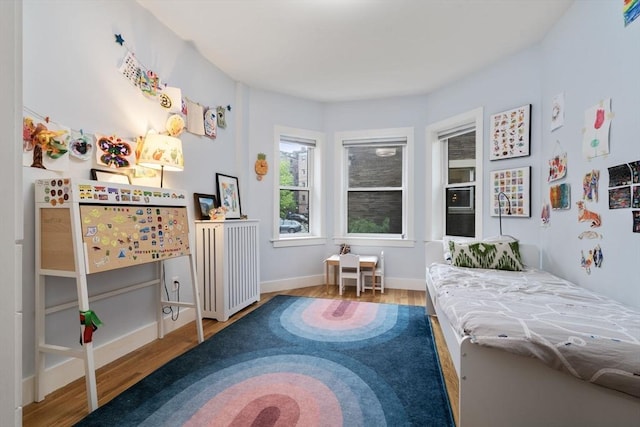 bedroom with wood finished floors and baseboards
