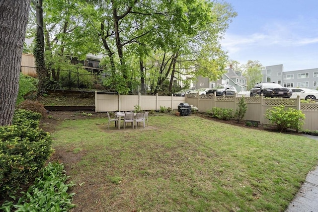 view of yard with a residential view and outdoor dining space