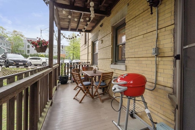 balcony featuring a porch, grilling area, and outdoor dining area